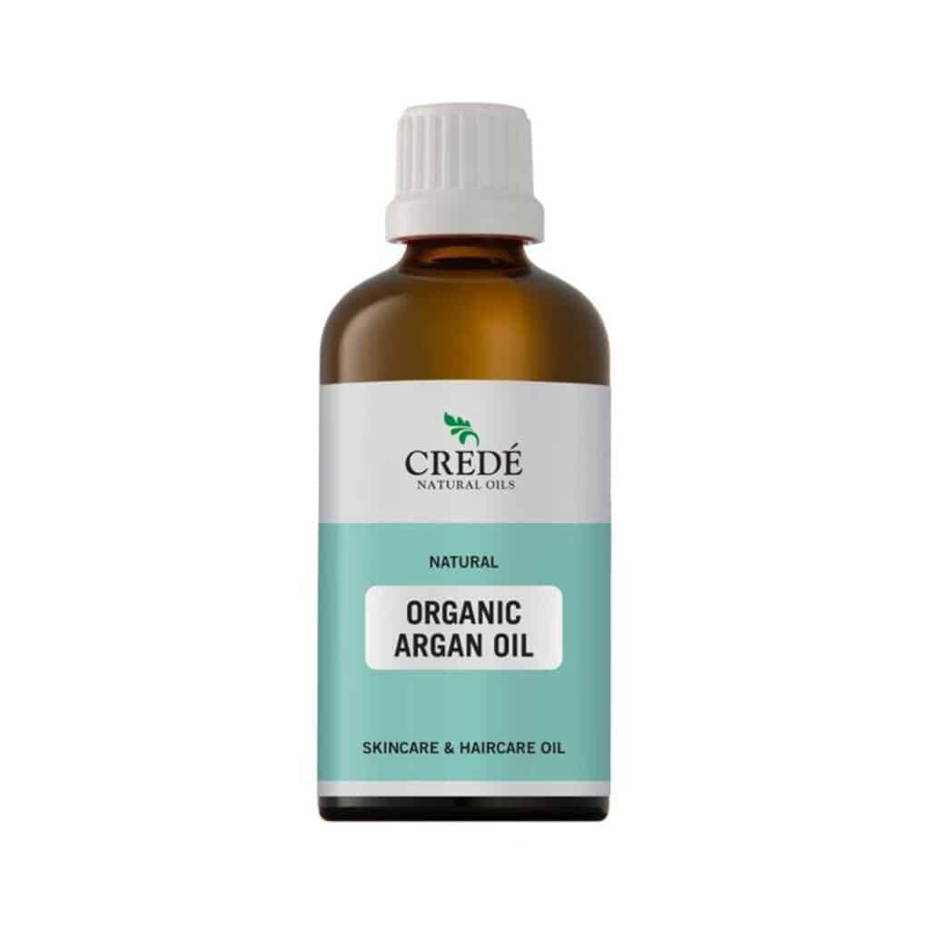 Crede Organic Argan Oil in a dark amber bottle with a dropper cap, showcasing the golden oil, perfect for skin and hair care.
