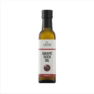 Crede Grapeseed Oil in a clear bottle with a green label, showcasing the light, golden oil, suitable for cooking and skin care.