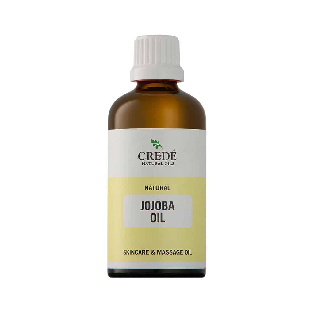 Crede Jojoba Oil in a clear bottle with a dropper cap, showcasing the light golden oil, perfect for skin and hair care.
