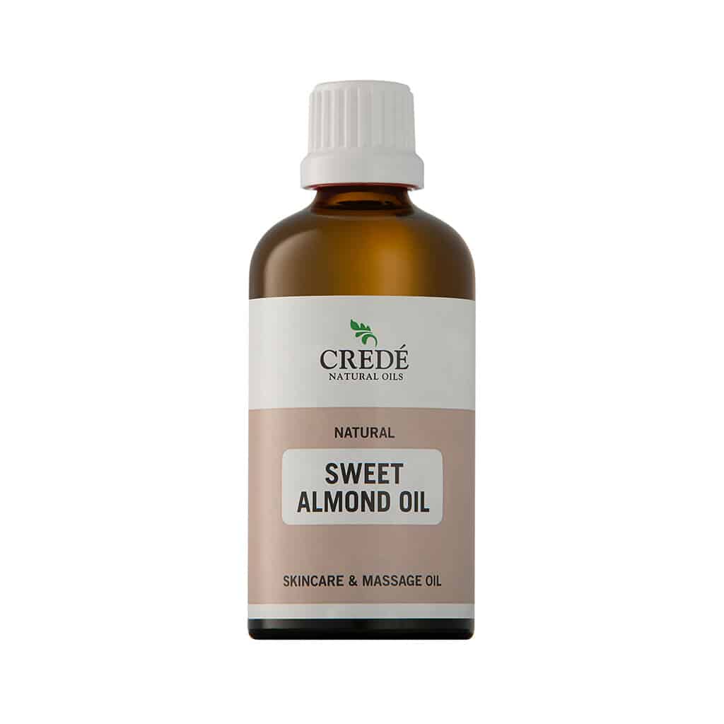 Crede Almond Oil in a clear bottle with a pump dispenser, showcasing the light golden oil, perfect for skin and hair care.
