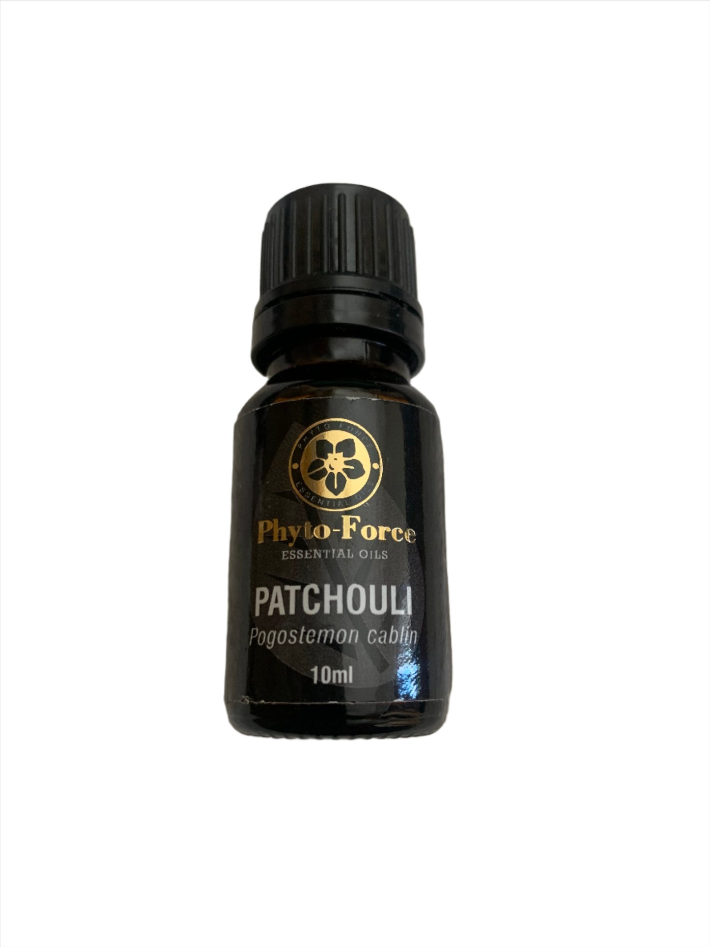 A bottle of Phyto-Force Organic Patchouli Essential Oil with its natural and organic label, placed next to fresh patchouli leaves.