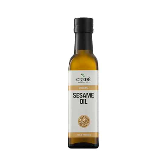 Crede Organic Sesame Oil in a dark amber bottle with a pour spout, showcasing the light golden oil, ideal for cooking and skin care.