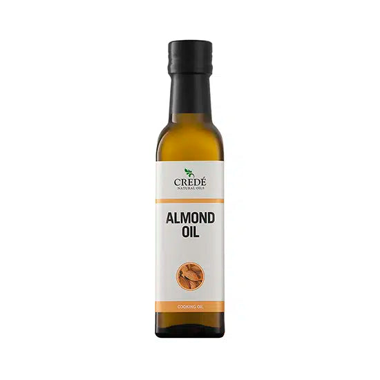 Crede Almond Oil in a clear bottle with a pump dispenser, showcasing the light golden oil, perfect for skin and hair care.