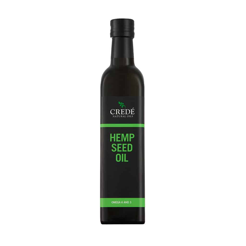 Crede Hempseed Oil in a dark amber bottle with a pour spout, showcasing the light green oil, perfect for enhancing health and wellness.