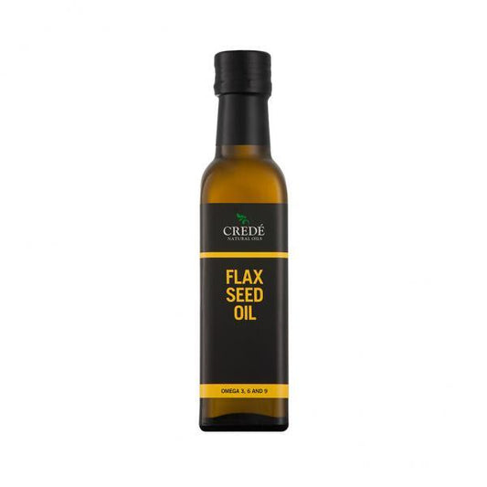 Crede Flaxseed Oil in a dark amber bottle with a pour spout, showcasing the golden oil, perfect for enhancing health and wellness.