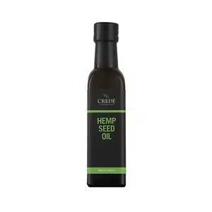 Crede Hempseed Oil in a dark amber bottle with a pour spout, showcasing the light green oil, perfect for enhancing health and wellness.