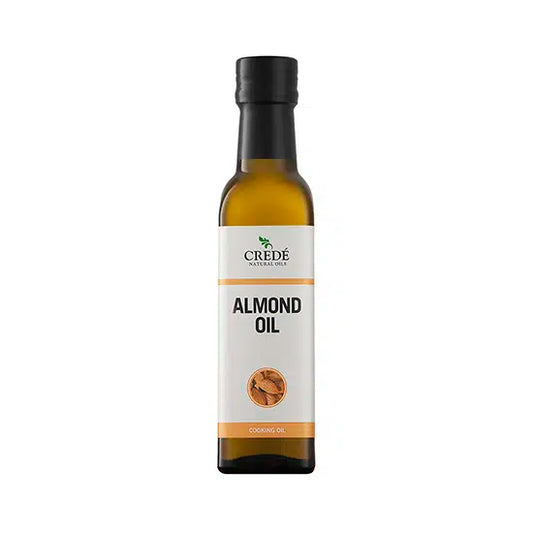 Crede Almond Oil in a clear bottle with a pump dispenser, showcasing the light golden oil, perfect for skin and hair care.