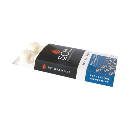 Soil soy wax melts with black-and-blue pack and clear tray of white wax pieces